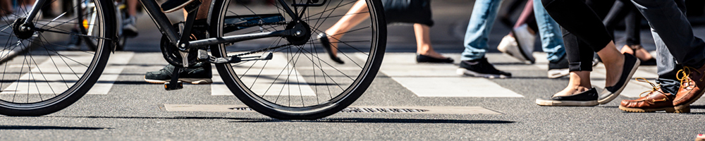 Zebrastreifen, über den Fußgänger gehen und Fahrradfahrer fahren.